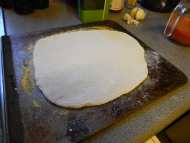 The polenta stops the pizza base from sticking to the tray, so it's easy to shuffle onto the stone