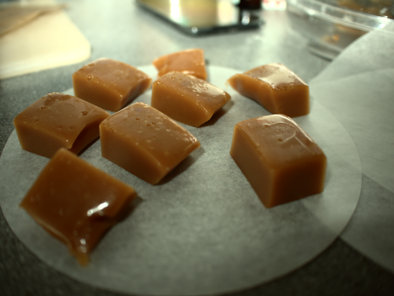 Salted caramels, carefully placed on non-stick paper.
